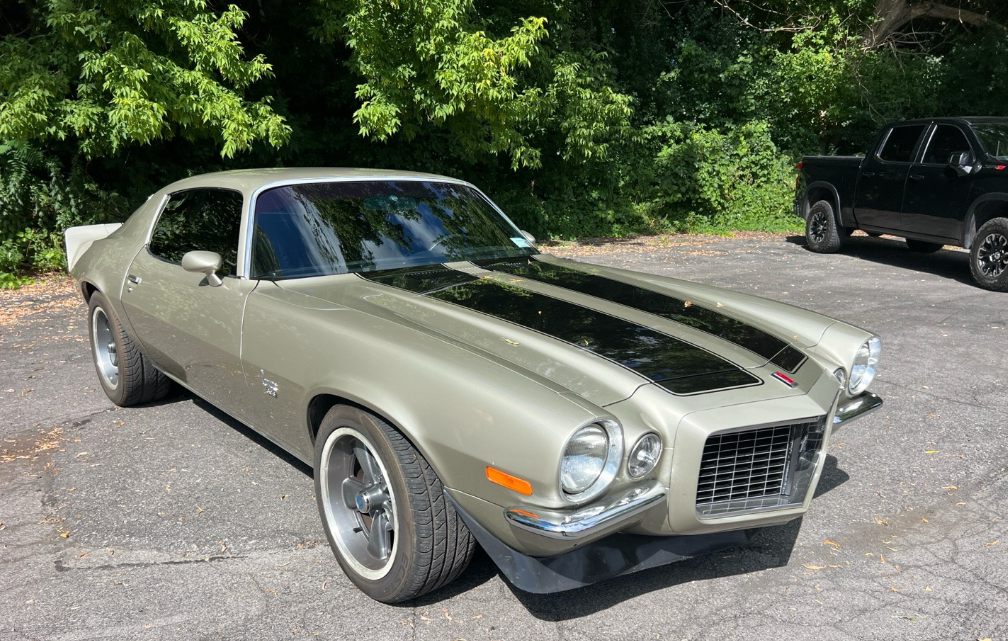Green 1971 Chevrolet Camaro Z28 split bumper transported by Allstar Hauling