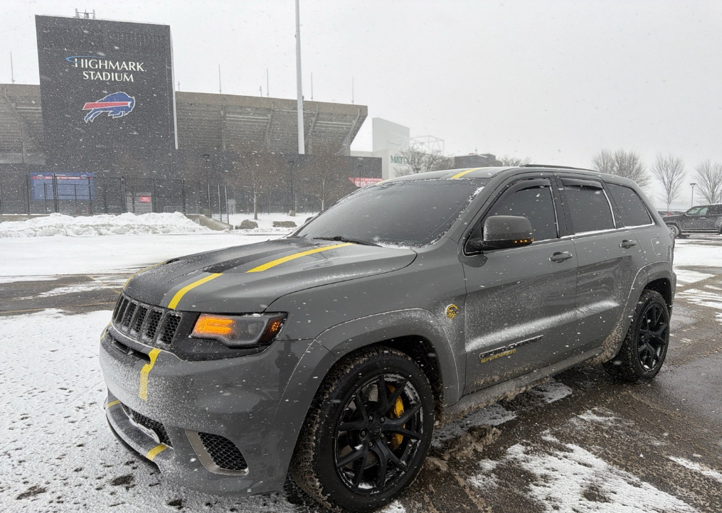 Gray Jeep Grand Cherokee Trackhawk transported by Allstar Hauling in the snow at Highmark Stadium