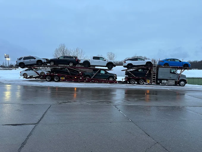 Ford Raptor and SUVs loaded on an Allstar Hauling carrier in the winter