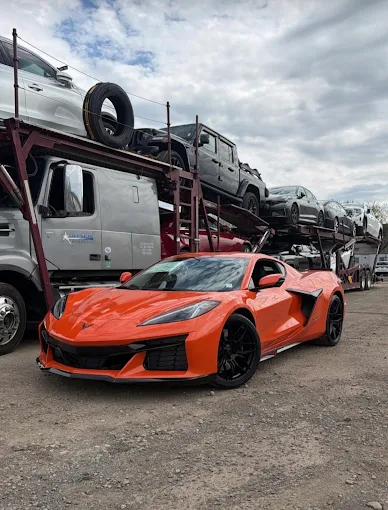 Orange Chevrolet Corvette C8 transported by Allstar Hauling