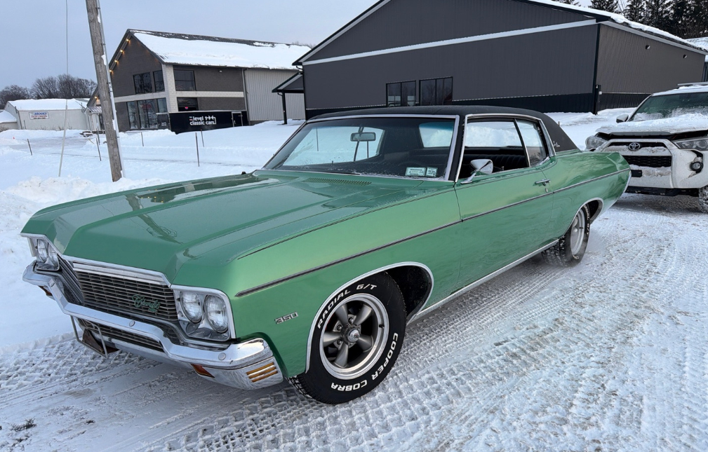 Green 1970 Chevrolet Impala in snow before Allstar Hauling transport