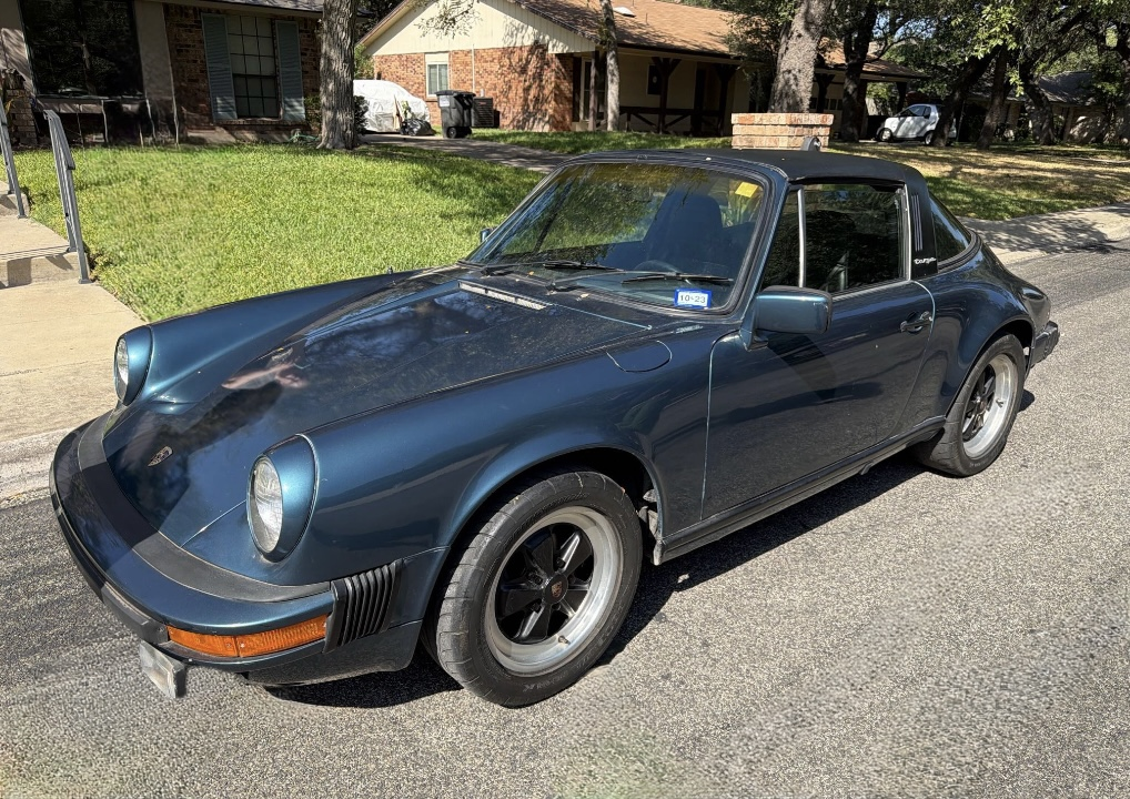 Blue Porsche 911 Carrera Cabriolet transported by Allstar Hauling